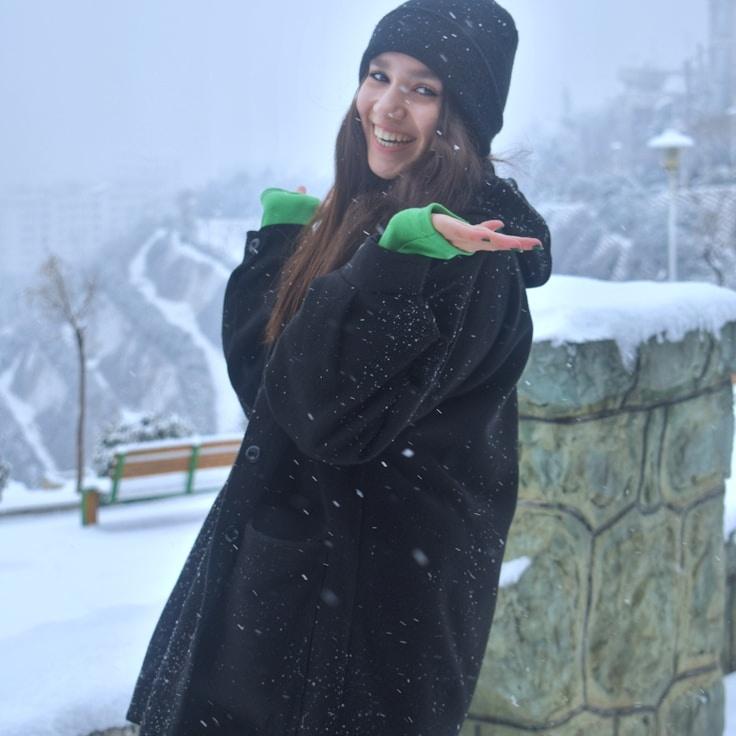 Kaveri Mehta, Lead Design Curator at Ledger Forest Paper, reviewing corporate floral arrangements
